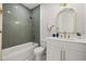 Modern bathroom with green tile, white vanity, and gold fixtures at 125 48Th N Ave, St Petersburg, FL 33703