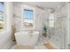 Spa-like bathroom featuring a soaking tub, walk-in shower, and marble finishes at 125 48Th N Ave, St Petersburg, FL 33703