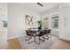 Dining room with glass table, brown leather chairs, and hardwood floors at 125 48Th N Ave, St Petersburg, FL 33703