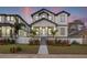 Two-story modern farmhouse with gray and white exterior, landscaping, and walkway at 125 48Th N Ave, St Petersburg, FL 33703