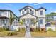 Two-story house with white siding, black accents and a landscaped yard at 125 48Th N Ave, St Petersburg, FL 33703