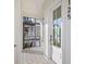 Front entry with white door, patterned tile floor, and a balcony at 125 48Th N Ave, St Petersburg, FL 33703