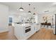 Modern white kitchen with marble island, microwave, and stainless steel appliances at 125 48Th N Ave, St Petersburg, FL 33703