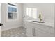 Laundry room with patterned tile floor and white cabinets at 125 48Th N Ave, St Petersburg, FL 33703