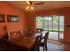 Dining room with wooden table, chairs and access to the screened patio at 4922 Lake Valencia W Blvd, Palm Harbor, FL 34684