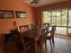 Dining room with wooden table, chairs and access to the screened patio at 4922 Lake Valencia W Blvd, Palm Harbor, FL 34684