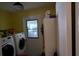 Bright laundry room with washer, dryer, and storage at 4922 Lake Valencia W Blvd, Palm Harbor, FL 34684