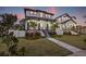 Two-story house with gray and white exterior, front porch, and landscaped yard at 135 48Th Ave, St Petersburg, FL 33703