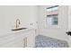 Laundry room with white cabinets, patterned floor and window at 135 48Th Ave, St Petersburg, FL 33703