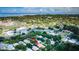 Aerial view of home with a tile roof in a neighborhood with lush greenery at 441 Village Dr, Tarpon Springs, FL 34689