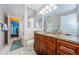 Clean bathroom with double sinks, granite countertop, and tile shower at 957 Westwinds Blvd, Tarpon Springs, FL 34689
