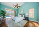 Main bedroom with light walls, wood floors, and access to the pool at 957 Westwinds Blvd, Tarpon Springs, FL 34689