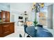 Bright dining area with dark table and chairs, open to kitchen and living room at 957 Westwinds Blvd, Tarpon Springs, FL 34689