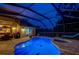 Inviting pool area at night with lighting and patio furniture at 957 Westwinds Blvd, Tarpon Springs, FL 34689