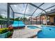Relaxing pool and spa area with lounge chairs and screened enclosure at 957 Westwinds Blvd, Tarpon Springs, FL 34689