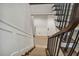 Elegant basement stairs with wood railing and neutral carpet at 18 Franklin S Ct # A, St Petersburg, FL 33711