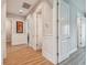 Bright hallway with hardwood floors and white doors leading to bedrooms at 18 Franklin S Ct # A, St Petersburg, FL 33711