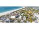 Breathtaking aerial view of coastal community with beach access, lush greenery, and charming homes at 108 14Th Ave # 3, St Pete Beach, FL 33706