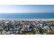 Beautiful aerial view of neighborhood homes near beach with ocean backdrop offering prime coastal living at 108 14Th Ave # 3, St Pete Beach, FL 33706