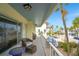 Relaxing balcony with cozy wicker furniture, tropical views, and distant ocean at 108 14Th Ave # 3, St Pete Beach, FL 33706