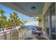 Relax on this inviting balcony with seating, a table, and charming street views filled with palm trees and coastal charm at 108 14Th Ave # 3, St Pete Beach, FL 33706