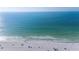 Scenic aerial view of a sandy beach with clear blue ocean water, perfect for relaxation and recreation at 108 14Th Ave # 3, St Pete Beach, FL 33706