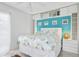 Cozy bedroom with white walls and ocean-themed bedding and turquoise accents at 108 14Th Ave # 3, St Pete Beach, FL 33706