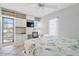 Bedroom showcases a built-in desk area, a ceiling fan and natural light from the windows at 108 14Th Ave # 3, St Pete Beach, FL 33706