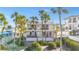 Charming two-story condo building with tropical landscaping, palm trees, and white railings at 108 14Th Ave # 3, St Pete Beach, FL 33706