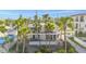 Inviting multi-story home featuring balconies and lush palm trees, offering a tropical and serene living environment at 108 14Th Ave # 3, St Pete Beach, FL 33706