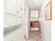 Bright hallway features white tile floors and neutral paint leading to the kitchen at 108 14Th Ave # 3, St Pete Beach, FL 33706