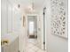 Bright hallway with white tile floors, white walls, and white trim at 108 14Th Ave # 3, St Pete Beach, FL 33706