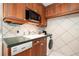 The kitchen has updated stainless appliances, a washer/dryer, and wood cabinets at 108 14Th Ave # 3, St Pete Beach, FL 33706