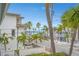 Charming street view featuring palm trees and a glimpse of the ocean in a vibrant coastal neighborhood at 108 14Th Ave # 3, St Pete Beach, FL 33706