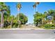 Inviting street view with a path leading to the water, surrounded by lush greenery and palm trees at 108 14Th Ave # 3, St Pete Beach, FL 33706