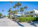 A lovely view of a street with condos, palm trees, and lush tropical greenery at 108 14Th Ave # 3, St Pete Beach, FL 33706