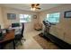 Home office featuring a desk, treadmill, and comfortable chair at 1964 Arvis E Cir, Clearwater, FL 33764