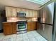 Bright kitchen, stainless steel appliances and light wood cabinets at 1964 Arvis E Cir, Clearwater, FL 33764