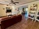 Spacious living room featuring a large leather sofa and tile floors at 1964 Arvis E Cir, Clearwater, FL 33764