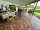 Outdoor patio with brick flooring, bar, and seating area at 1964 Arvis E Cir, Clearwater, FL 33764