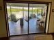 View from inside, looking out to a patio with river view and fire pit at 1964 Arvis E Cir, Clearwater, FL 33764