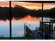 Serene sunset reflecting on calm water, seen from a home's porch at 1964 Arvis E Cir, Clearwater, FL 33764