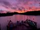 Stunning sunset over calm water, seen from a private dock with kayaks at 1964 Arvis E Cir, Clearwater, FL 33764