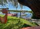 Relaxing waterfront view with dock, hammock, and small boat at 1964 Arvis E Cir, Clearwater, FL 33764