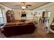 Living room with leather sofa and a view into dining area at 1964 Arvis E Cir, Clearwater, FL 33764