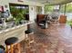 Outdoor kitchen with tiled counter, sink, and seating at 1964 Arvis E Cir, Clearwater, FL 33764