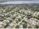 Aerial view of a residential neighborhood with houses, pools, and lush green spaces at 2098 Swan Ln, Safety Harbor, FL 34695