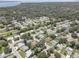 Aerial view of a residential neighborhood with houses, pools, and lush green spaces at 2098 Swan Ln, Safety Harbor, FL 34695