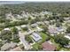 Aerial view of a residential neighborhood with houses, pools, and lush green spaces at 2098 Swan Ln, Safety Harbor, FL 34695