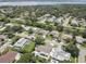 Aerial view showcasing a neighborhood near a body of water, featuring numerous houses and pools at 2098 Swan Ln, Safety Harbor, FL 34695